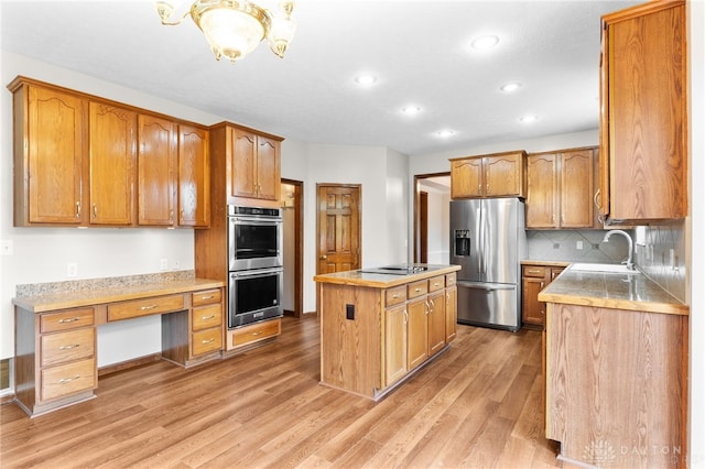 2159 Bassett Ct, Beavercreek, OH 45434 - kitchen with stainless steel appliances, a sink, recessed lighting, light wood-style floors, and a center island