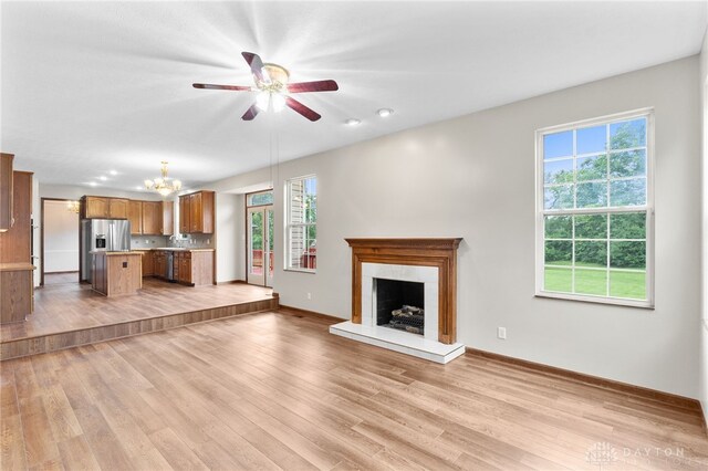 2159 Bassett Ct, Beavercreek, OH 45434 - unfurnished living room featuring a chandelier, healthy amount of natural light, baseboards, and recessed lighting