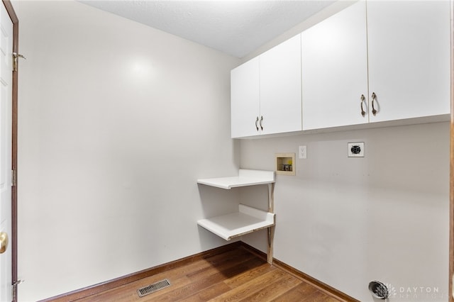 2159 Bassett Ct, Beavercreek, OH 45434 - washroom featuring cabinet space, electric dryer hookup, light wood-style floors, hookup for a washing machine, and baseboards
