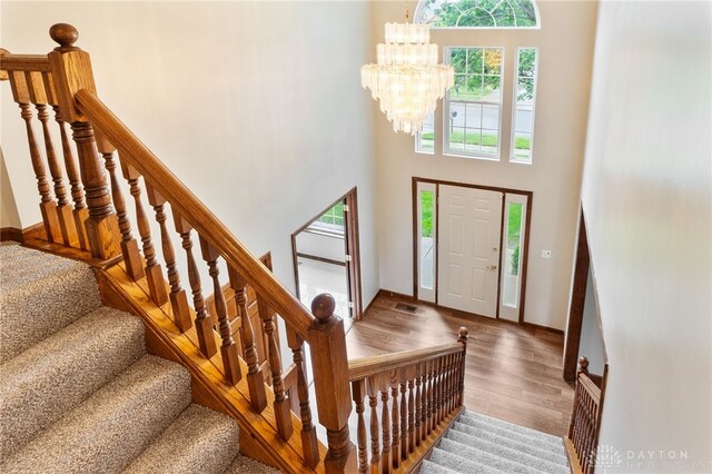 2159 Bassett Ct, Beavercreek, OH 45434 - entryway featuring a chandelier, wood finished floors, a towering ceiling, baseboards, and stairway