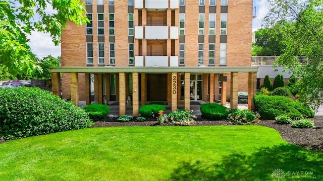 2230 S Patterson Blvd Unit 21, Dayton, OH 45409 - rear view of property with brick siding and a yard