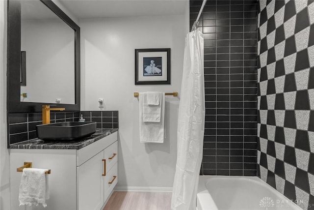 2230 S Patterson Blvd Unit 21, Dayton, OH 45409 - full bath featuring vanity, shower / bath combo with shower curtain, wood finished floors, and baseboards