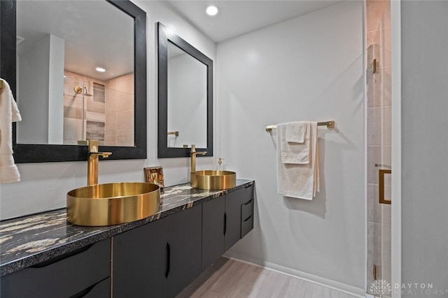 2230 S Patterson Blvd Unit 21, Dayton, OH 45409 - full bath featuring double vanity, a shower stall, and wood finished floors