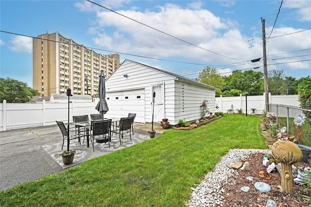 1064 Wilmington Ave, Dayton, OH 45420 - view of yard featuring an outbuilding, a patio area, and a detached garage
