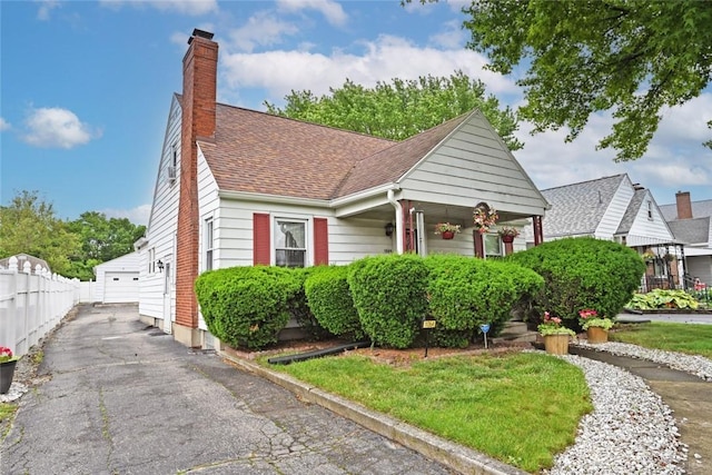 1064 Wilmington Ave, Dayton, OH 45420 - bungalow-style home with a chimney, a garage, a shingled roof, and a porch