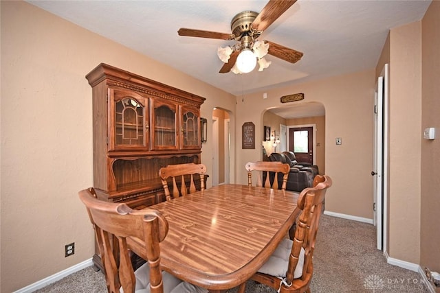 1064 Wilmington Ave, Dayton, OH 45420 - carpeted dining area featuring arched walkways, ceiling fan, and baseboards