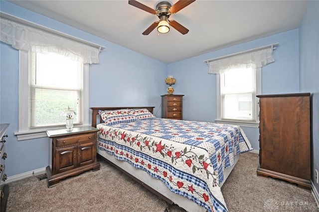1064 Wilmington Ave, Dayton, OH 45420 - carpeted bedroom with multiple windows, a ceiling fan, and baseboards