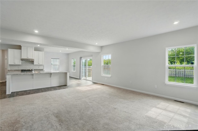 344 Warm Springs Dr, Fairborn, OH 45324 - unfurnished living room with baseboards, recessed lighting, beamed ceiling, and light carpet