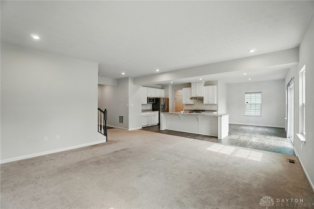 344 Warm Springs Dr, Fairborn, OH 45324 - unfurnished living room with carpet, baseboards, recessed lighting, and stairs