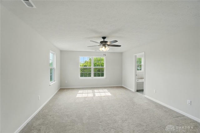 344 Warm Springs Dr, Fairborn, OH 45324 - spare room with plenty of natural light, ceiling fan, baseboards, carpet flooring, and a textured ceiling