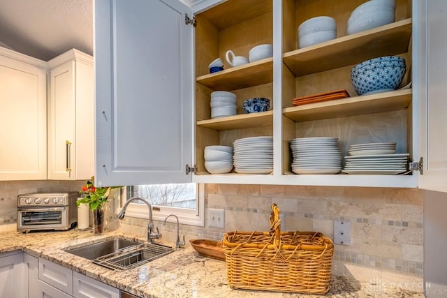 1126 Justin Ridge Way, Waynesville, OH 45068 - kitchen view of a sink, open shelves, white cabinets, and backsplash