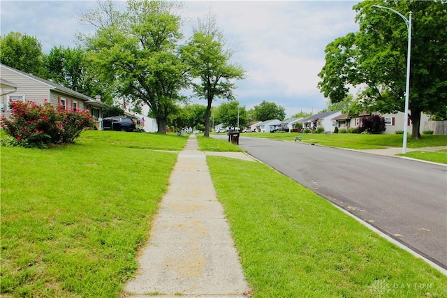 2589 Midvale St, Dayton, OH 45420 - view of asphalt street featuring a residential view, sidewalks, and street lighting