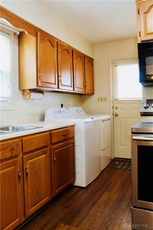 2589 Midvale St, Dayton, OH 45420 - washroom with washing machine and clothes dryer and dark wood-style floors