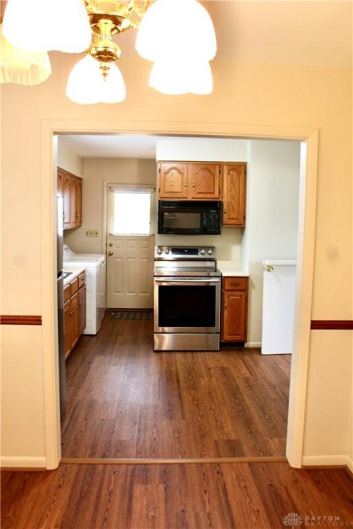2589 Midvale St, Dayton, OH 45420 - kitchen featuring appliances with stainless steel finishes, separate washer and dryer, light countertops, and dark wood-type flooring