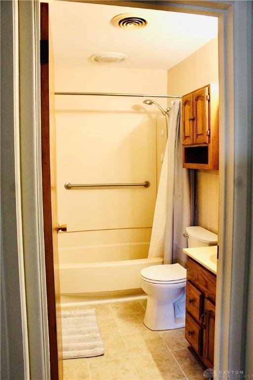 2589 Midvale St, Dayton, OH 45420 - bathroom featuring vanity, toilet, shower / bath combination with curtain, and tile patterned floors