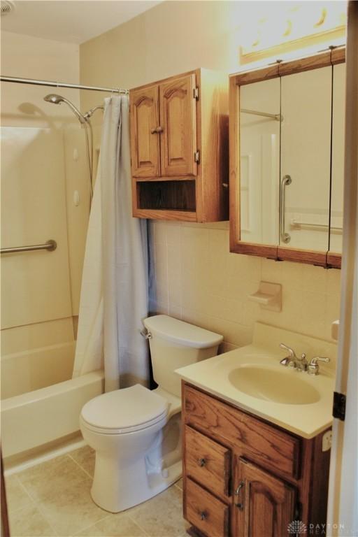 2589 Midvale St, Dayton, OH 45420 - bathroom featuring vanity, shower / bath combo with shower curtain, toilet, and tile patterned flooring