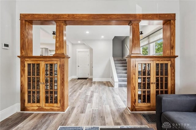 1153 Highridge Ave, Dayton, OH 45420 - living room featuring wood finished floors, ornate columns, and stairs
