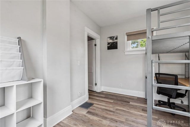 1153 Highridge Ave, Dayton, OH 45420 - unfurnished bedroom featuring wood finished floors and an office area