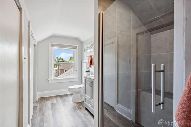 1153 Highridge Ave, Dayton, OH 45420 - full bathroom with vanity, vaulted ceiling, wood finished floors, and tiled shower