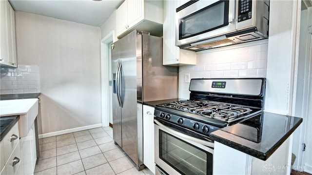344 Triangle Ave, Oakwood, OH 45419 - kitchen with stainless steel appliances, white cabinetry, backsplash, and dark countertops