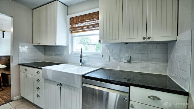 344 Triangle Ave, Oakwood, OH 45419 - kitchen with dark countertops, white cabinetry, a sink, decorative backsplash, and light tile patterned floors