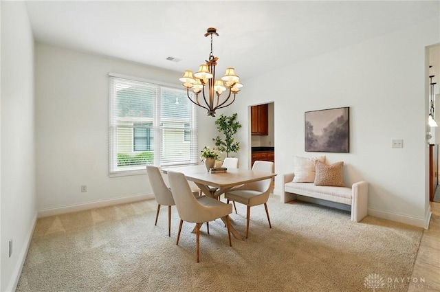 160 Harbour Dr, Springboro, OH 45066 - dining area featuring a chandelier, baseboards, and light colored carpet