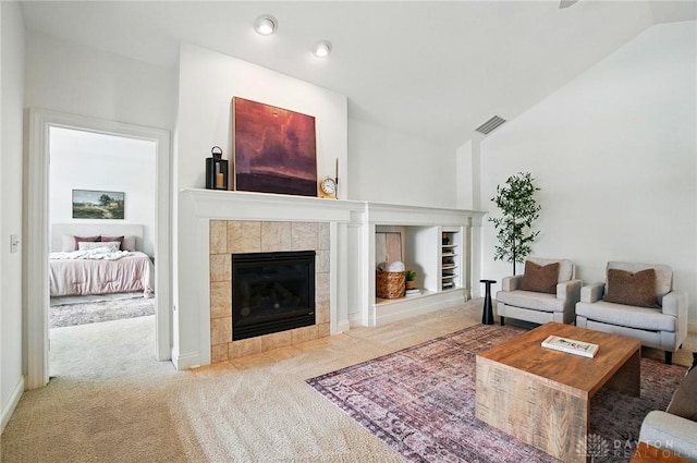 160 Harbour Dr, Springboro, OH 45066 - carpeted living area featuring vaulted ceiling, a tiled fireplace, and recessed lighting