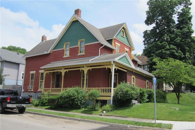 1600 Wayne Ave, Dayton, OH 45410 - victorian-style house featuring covered porch, brick siding, a chimney, and a front lawn