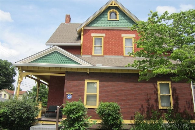 1600 Wayne Ave, Dayton, OH 45410 - rear view of property with brick siding, roof with shingles, and a chimney