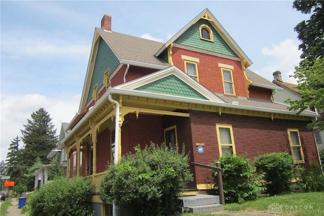 1600 Wayne Ave, Dayton, OH 45410 - view of front facade featuring a chimney, covered porch, and brick siding