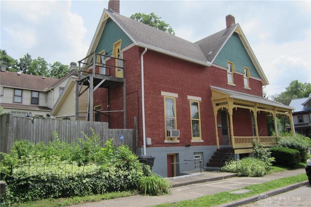 1600 Wayne Ave, Dayton, OH 45410 - victorian home featuring brick siding, a chimney, covered porch, and stairway