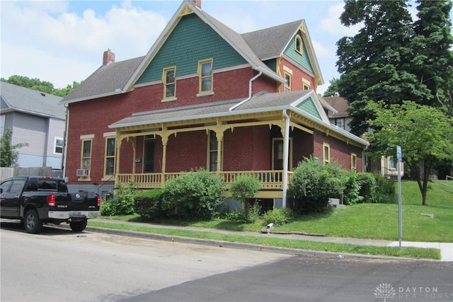 1600 Wayne Ave, Dayton, OH 45410 - victorian-style house featuring covered porch, a chimney, a front lawn, and brick siding