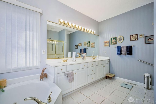 1668 Nichole Ct, Hamilton, OH 45013 - bathroom with a jetted tub, a shower stall, double vanity, tile patterned flooring, and baseboards