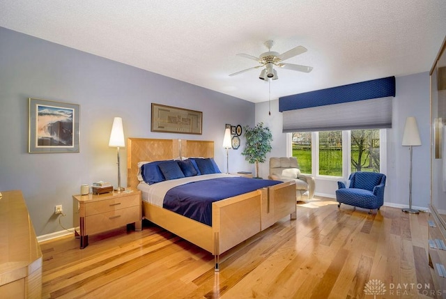1668 Nichole Ct, Hamilton, OH 45013 - bedroom with light wood-style flooring, baseboards, a textured ceiling, and a ceiling fan