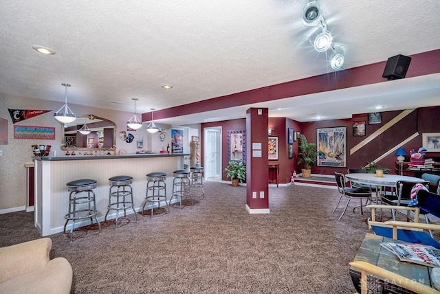 1668 Nichole Ct, Hamilton, OH 45013 - kitchen featuring a textured ceiling, carpet floors, baseboards, open floor plan, and hanging light fixtures