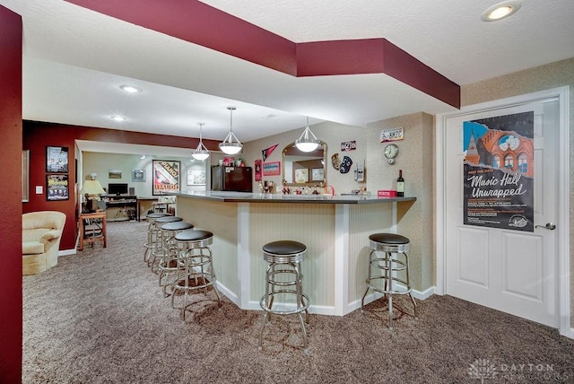 1668 Nichole Ct, Hamilton, OH 45013 - kitchen with freestanding refrigerator, carpet floors, a breakfast bar, recessed lighting, and a textured ceiling