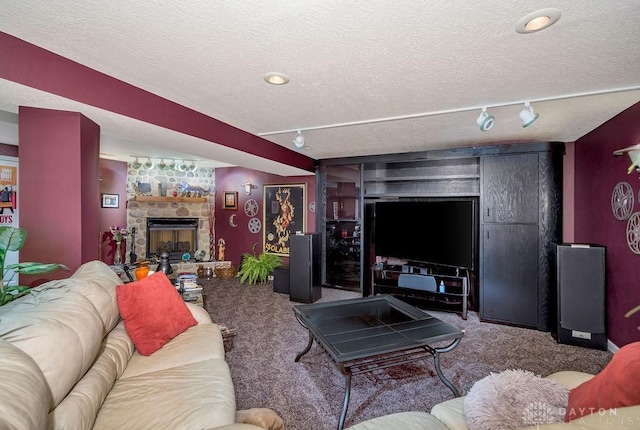 1668 Nichole Ct, Hamilton, OH 45013 - living room with carpet, track lighting, a textured ceiling, and a fireplace