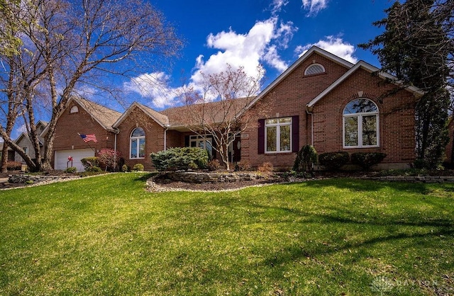 1668 Nichole Ct, Hamilton, OH 45013 - view of front of home with brick siding, a front lawn, and a garage