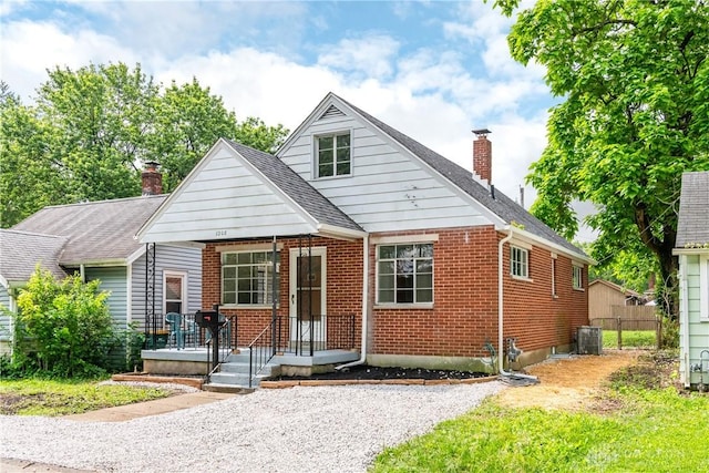 1208 Hale Ave, Dayton, OH 45419 - bungalow-style home with a chimney, brick siding, cooling unit, and a shingled roof