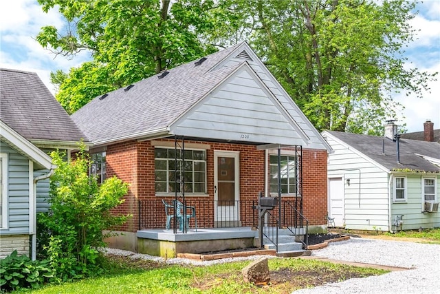 1208 Hale Ave, Dayton, OH 45419 - bungalow-style house featuring a porch, brick siding, a shingled roof, and cooling unit
