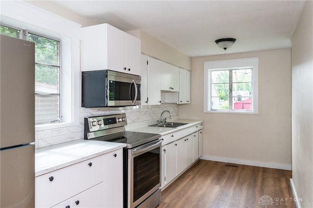 1208 Hale Ave, Dayton, OH 45419 - kitchen with appliances with stainless steel finishes, a sink, healthy amount of natural light, and tasteful backsplash