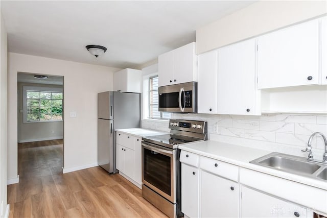 1208 Hale Ave, Dayton, OH 45419 - kitchen featuring stainless steel appliances, a sink, tasteful backsplash, and light countertops