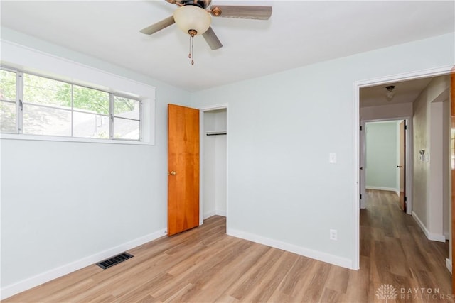 1208 Hale Ave, Dayton, OH 45419 - unfurnished bedroom featuring light wood finished floors, a closet, baseboards, and a ceiling fan