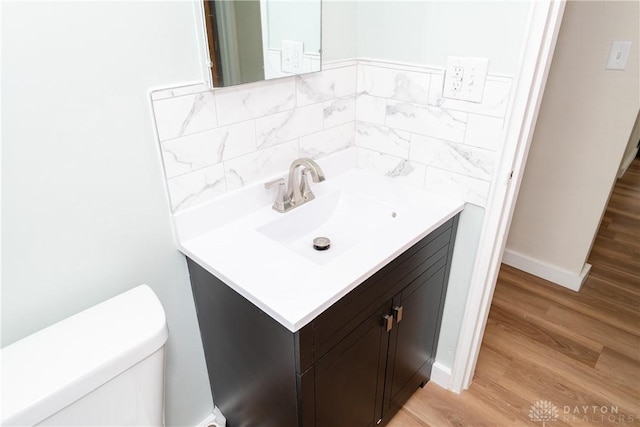 1208 Hale Ave, Dayton, OH 45419 - bathroom with vanity, toilet, wood finished floors, and baseboards