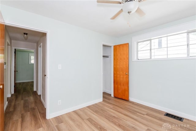 1208 Hale Ave, Dayton, OH 45419 - unfurnished bedroom featuring light wood-type flooring, a closet, baseboards, and multiple windows