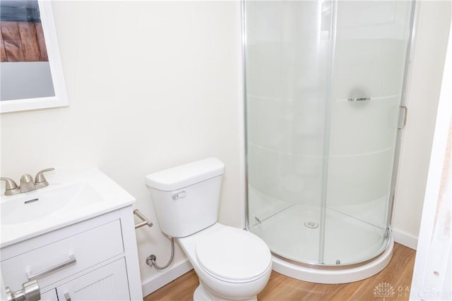 1208 Hale Ave, Dayton, OH 45419 - full bathroom featuring vanity, wood finished floors, a shower stall, and toilet