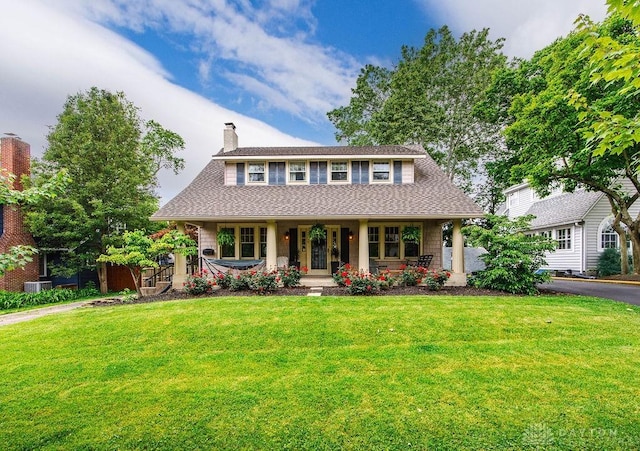 435 Marcia Ave, Hamilton, OH 45013 - view of front facade with covered porch, a front yard, a chimney, and driveway