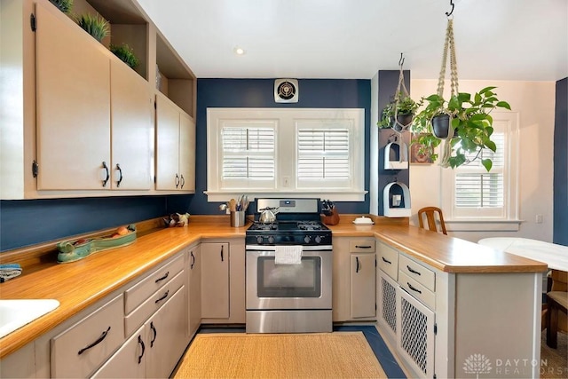 435 Marcia Ave, Hamilton, OH 45013 - kitchen with stainless steel range with gas cooktop, a peninsula, and light countertops