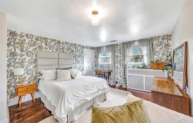 435 Marcia Ave, Hamilton, OH 45013 - bedroom with wallpapered walls, radiator heating unit, wood finished floors, and baseboards