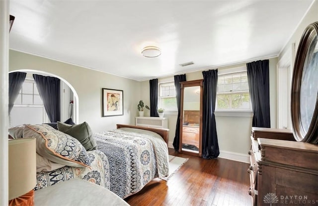 435 Marcia Ave, Hamilton, OH 45013 - bedroom featuring dark wood-style floors, baseboards, crown molding, and arched walkways